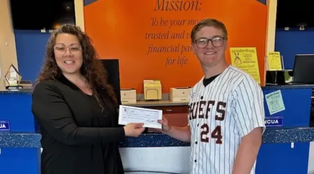 AAACU Team member presents a check to a member of the Cheboygan High School Senior Class of 2025